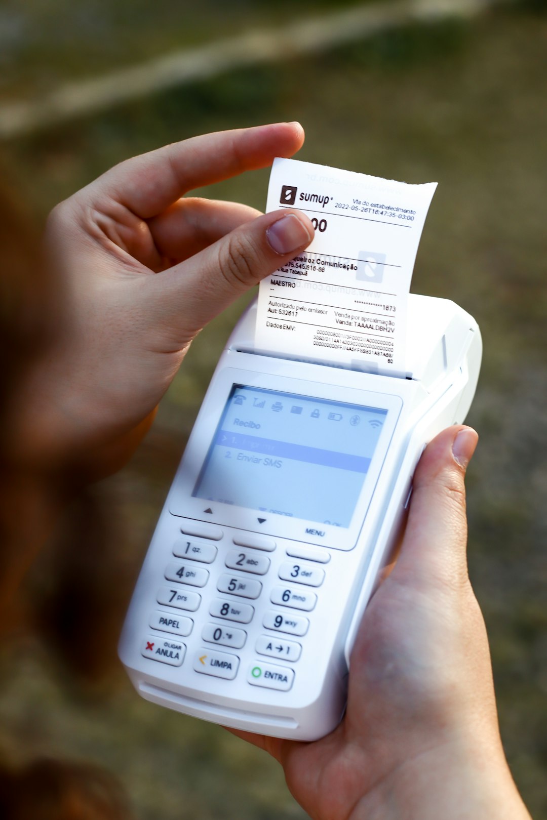a-person-holding-a-cell-phone-and-a-receipt-kndm23qurmi